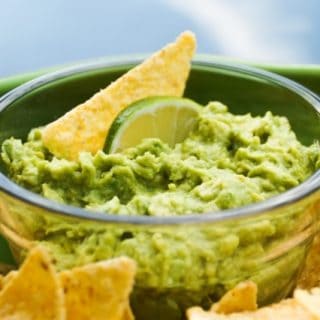 Bowl of guacamole surrounded by chips