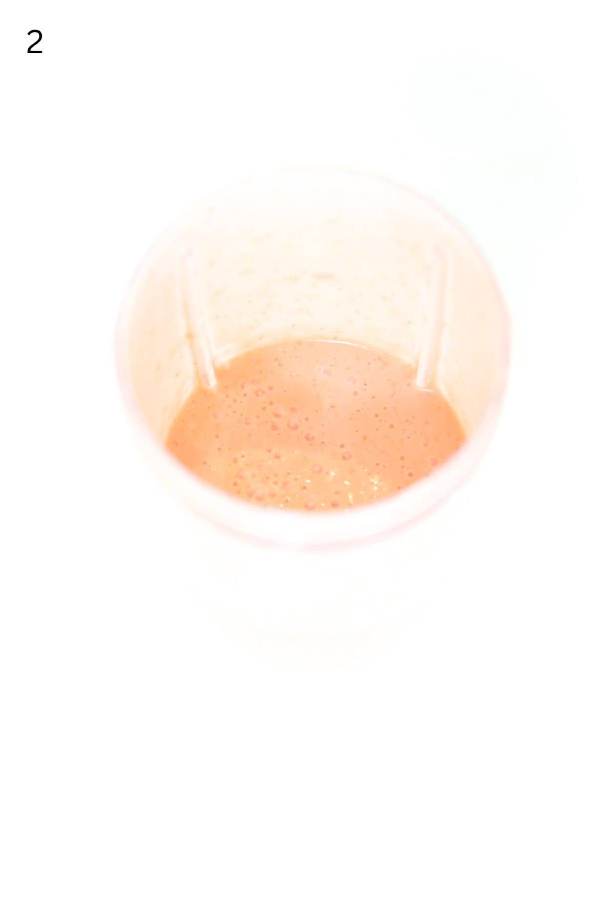 Strawberry salad dressing blended in a Nutri Bullet blender container.