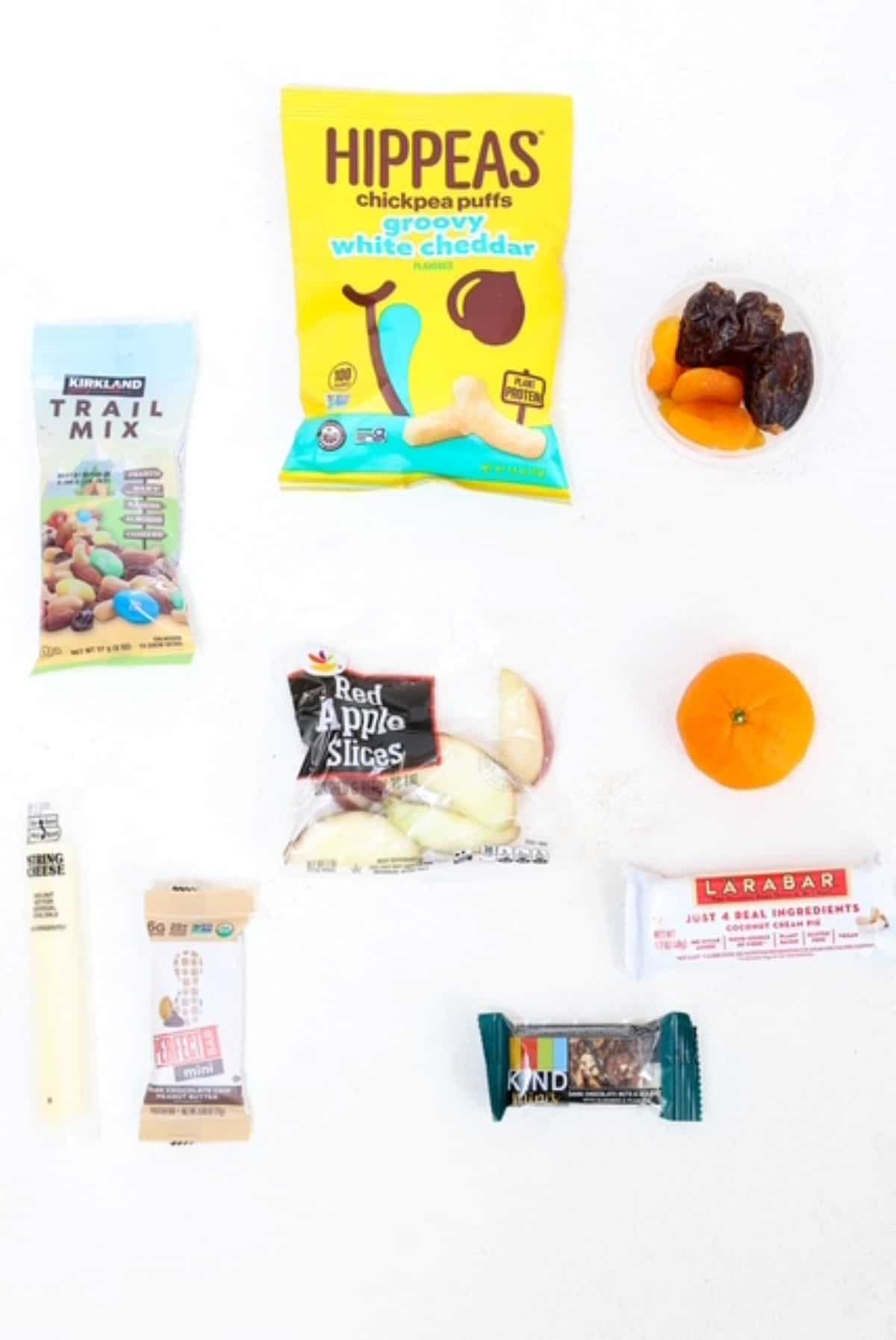 Ten different travel snacks with a white background.