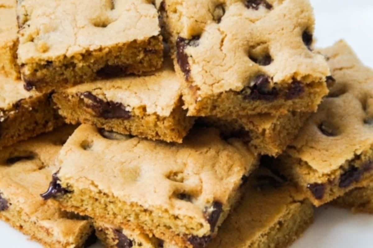 Stack of chocolate chip cookie bars on a white plate.