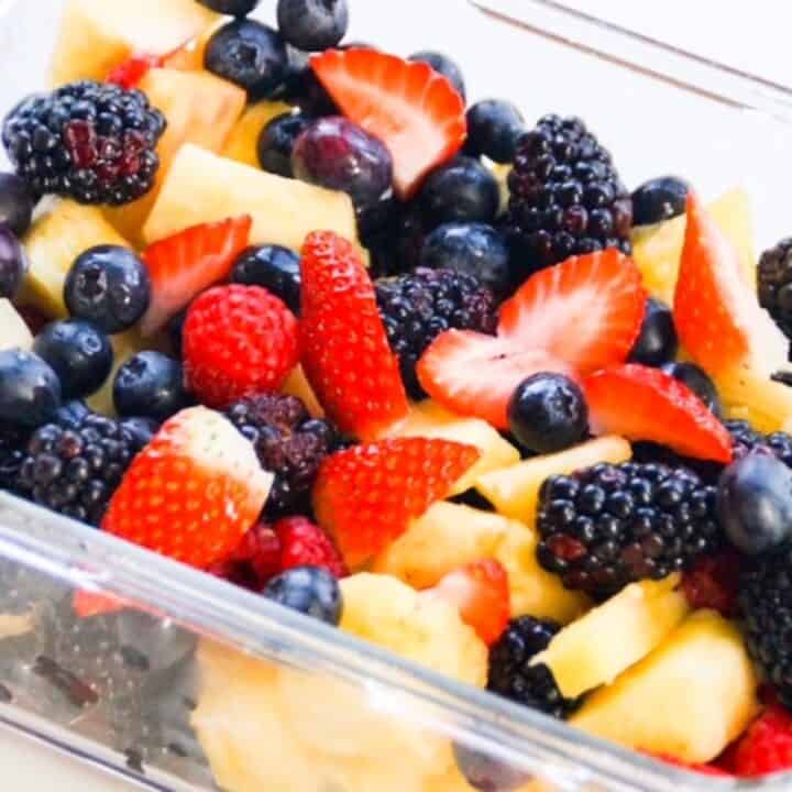 Fresh Fruit Salad in a glass storage container without a lid on.