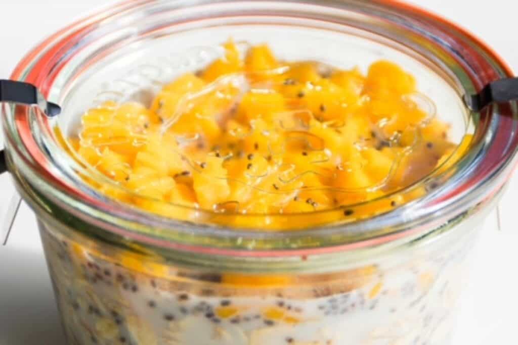 prepared mango overnight oats in a glass jar with a glass lid