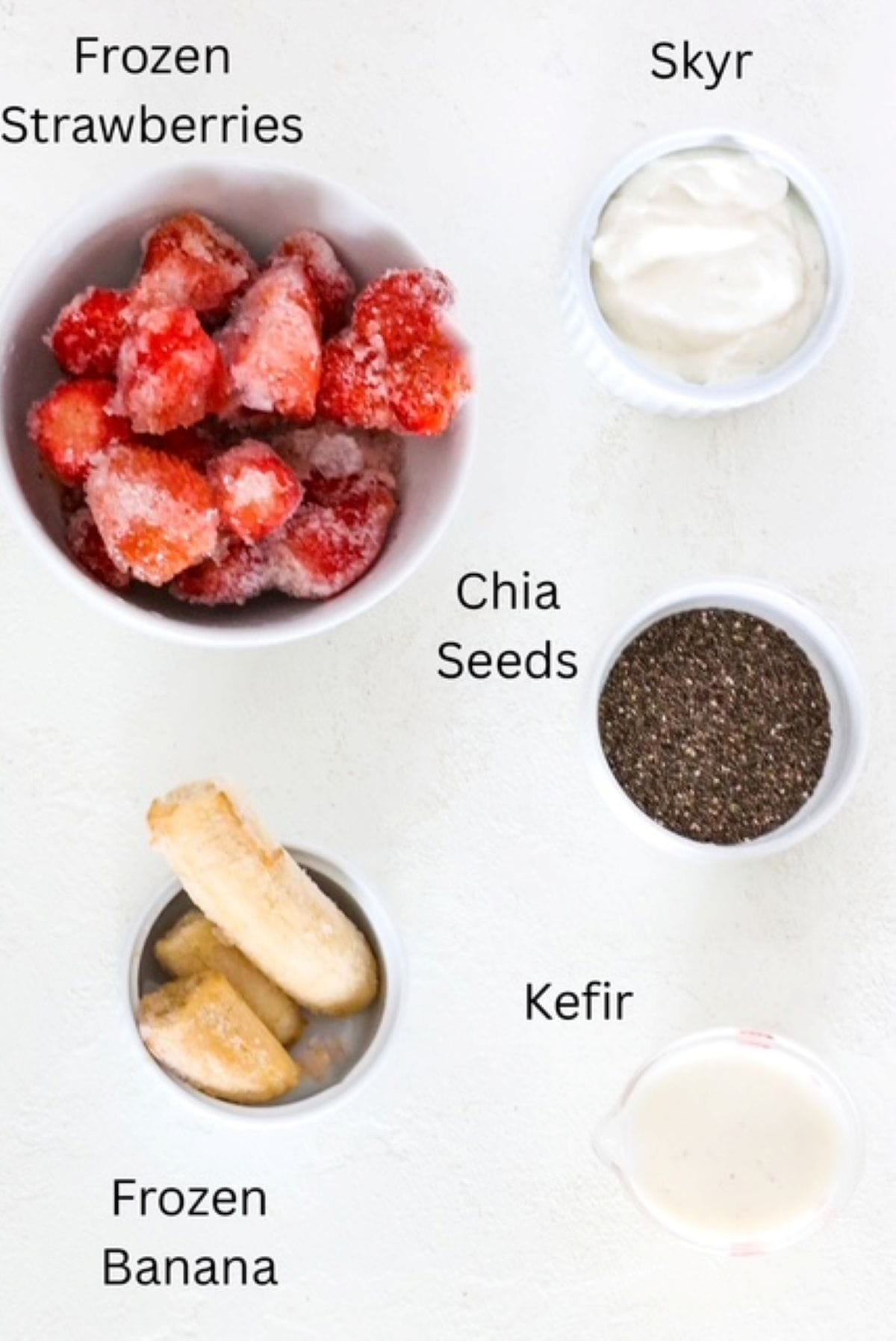 Ingredients for making strawberry smoothie bowls, labeled.