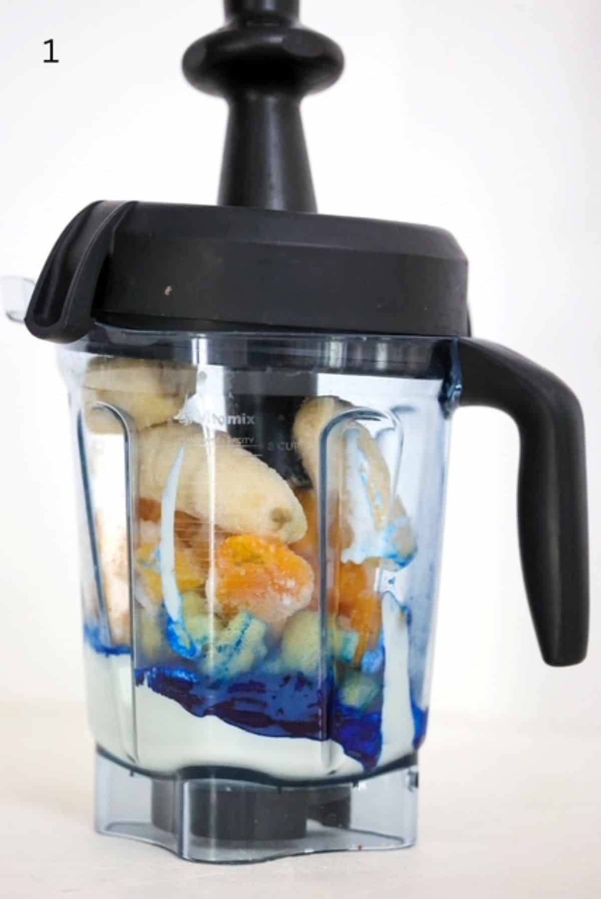 Blue smoothie bowl ingredients in a Vitamix blender.