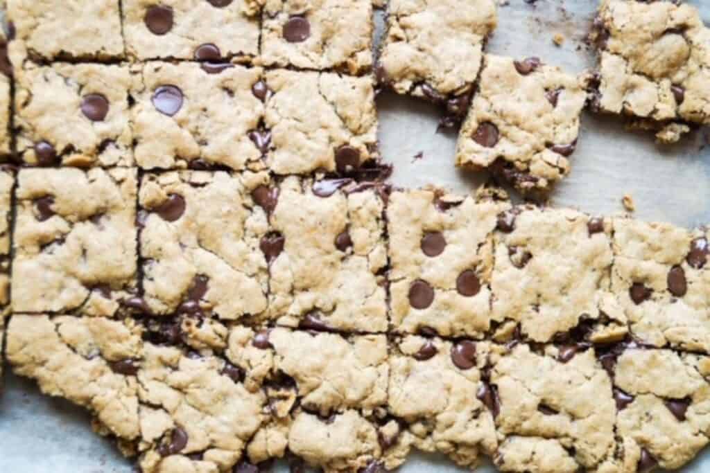 vegan blondies cut in squares while still on the pan.