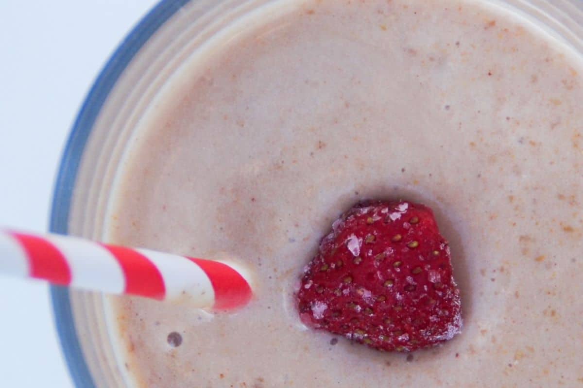 Smoothie topped with a frozen strawberry.