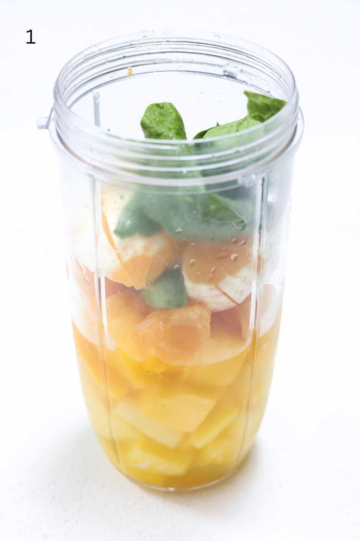 Island Green Tropical Smoothie ingredients in a NutriBullet Pro blender container.