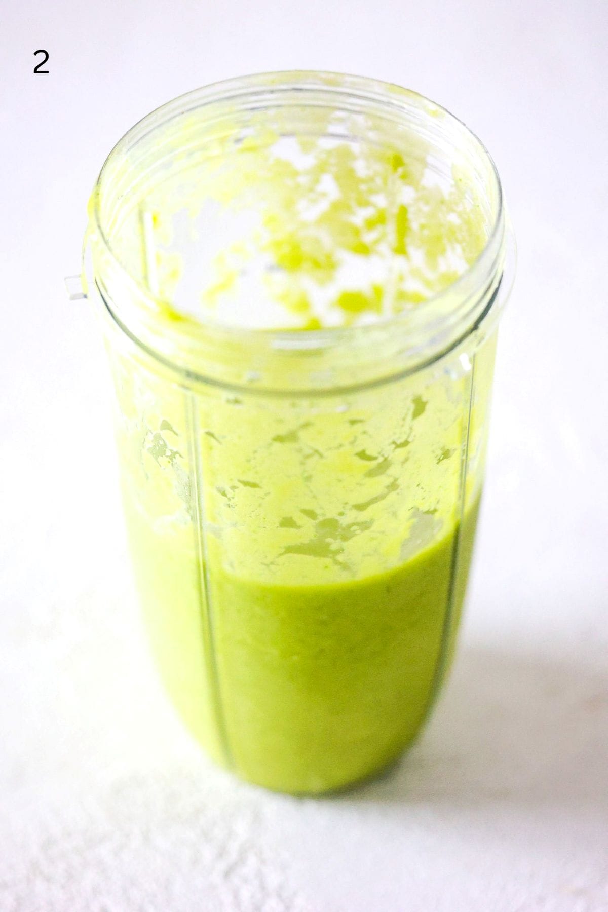 Tropical green smoothie in a NutriBullet Pro blender container.