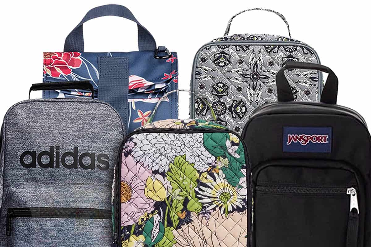 Five lunch boxes displayed in two rows. In the front row from left to right: Adidas (grey and black), Vera Bradley (floral pattern), Jansport backpack style (black). Back row: Roxy (blue floral pattern) and Vera Bradley (grey and black detail).