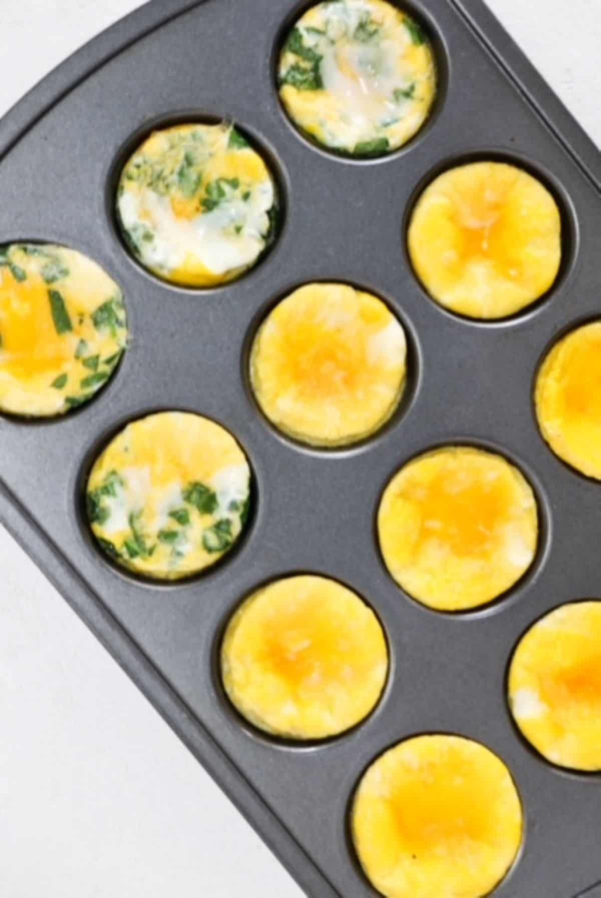 Baked eggs in a muffin tin, some plain and some with spinach and cheese.