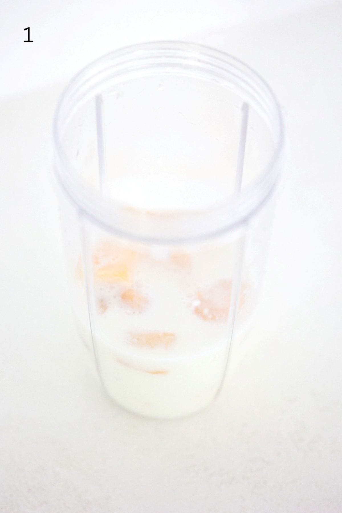 Mango Pineapple Fruit Smoothie ingredients in a NutriBullet Pro blender.