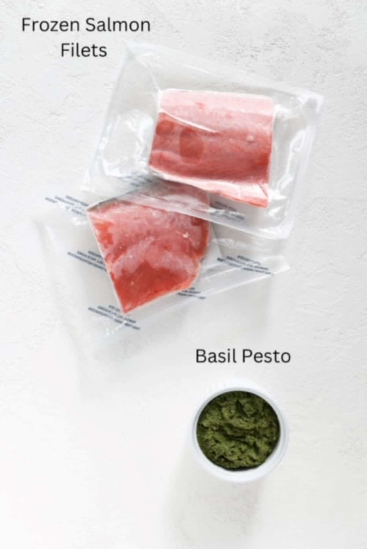 Two pieces of frozen salmon vacuum sealed and pesto in a white serving dish, labeled.