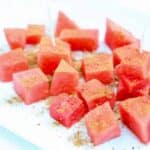 Chunks of fresh watermelon topped with Tajin and cinnamon.