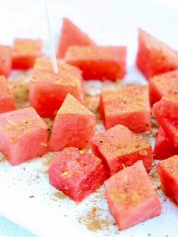 Chunks of fresh watermelon topped with Tajin and cinnamon.