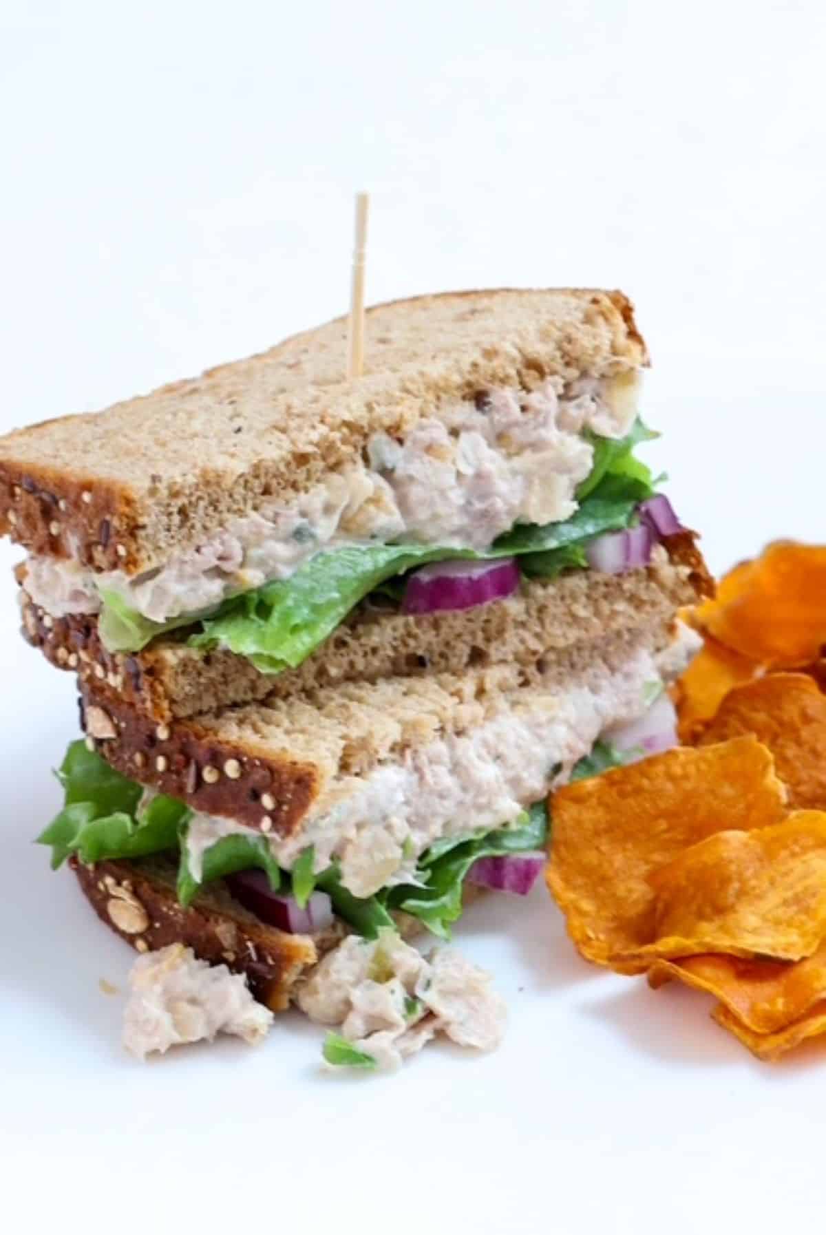 Tuna and Chickpea Salad sandwich on whole grain bread, halves stacked.